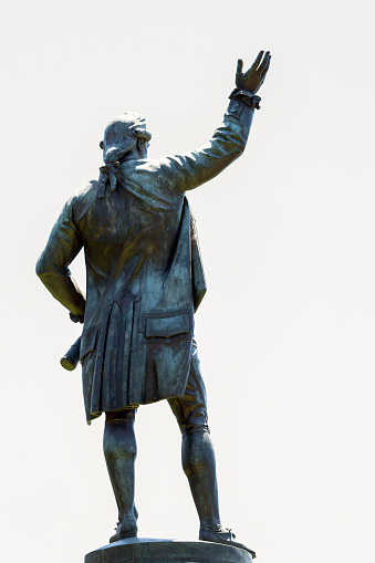 Alcala de Henares, Spain - June 18, 2022: Statue of Miguel de Cervantes and sub-scenes of his most famous novel The Quixote in the center of the square named after him in Alcala de Henares