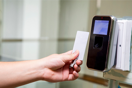 The hand with key card are scanning for enter digital security door system in the office building at Bangkok ,Thailand.