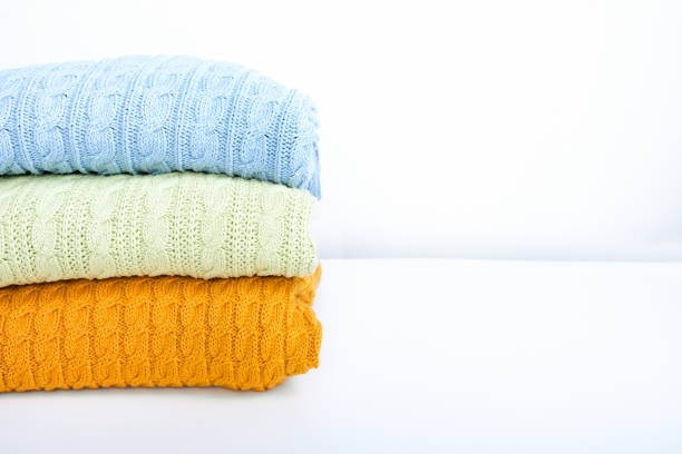 istock Stack of colorful cozy comfortable homely clean washed knitted sweaters in bright autumn fall colors, laundry and washing clothes concept, copy space 1286395657