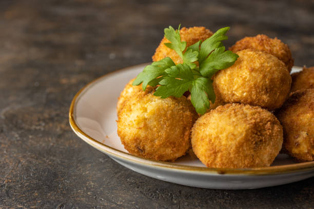 istock Italian risotto balls, arancini. Cheese Fried Risotto Balls 1286397922