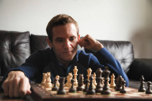 istock Close-up on pensive smiling trans autistic male over a chess board 1286399217