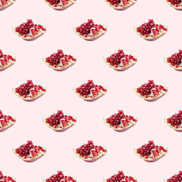 istock Bright red pomergranate pieces repeat seamless pattern on light pink background 1286400089