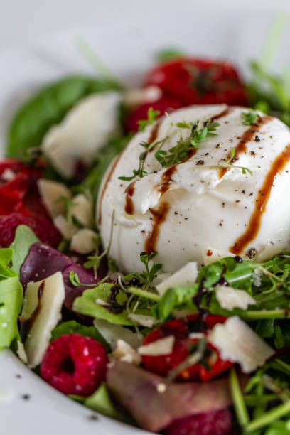 istock Salad with Italian burrata cheese, arugula, cherry tomatoes, parmesan and raspberry with balsamic glaze 1286400995