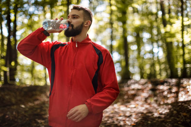 istock Portrait of young man hydrating in forest 1286401258