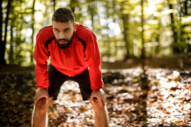 istock Portrait of young handsome man resting while exercising in nature 1286401495