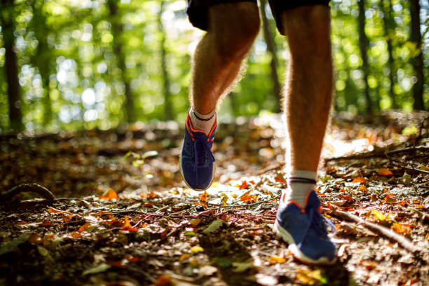 istock Unrecognizable young man jogging in the forest 1286401598
