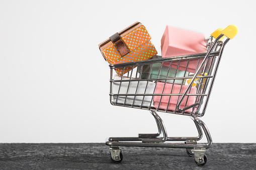 A shopping cart with presents. A close-up, shopping, a supermarket.