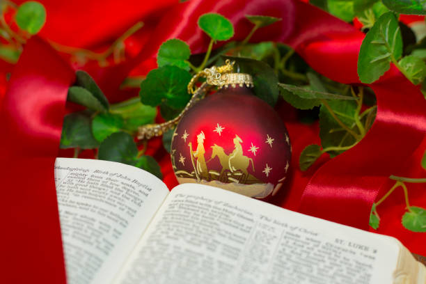 istock Nativity Red Christmas Ornament with Open Bible. 1286405306