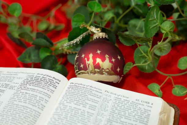 istock Nativity Red Christmas Ornament with Open Bible. 1286405309