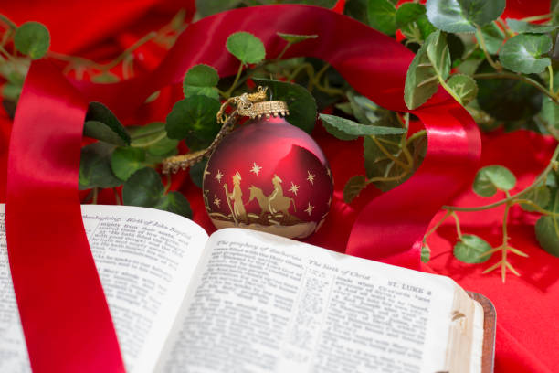 istock Nativity Red Christmas Ornament with Open Bible. 1286405311