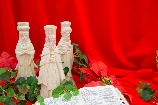Three Wise Men, Kings, bringing gifts to the Baby Jesus.  \nToday, wise men still seek Him and celebrate His birth.\nOpen Bible in foreground is the book of Luke, telling of the Birth of Christ.