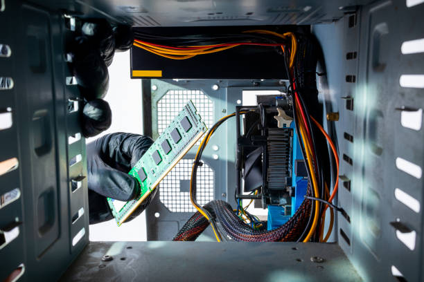 istock male person or technician worker installing ddr ram memory module to a desktop pc case. close up. looking inside computer case. appliance service concept 1286406602