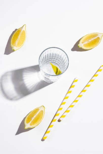 Mineral water with lemon on white background. Hard light Mineral water with lemon on white background. Hard light soda water glass lemon stock pictures, royalty-free photos & images