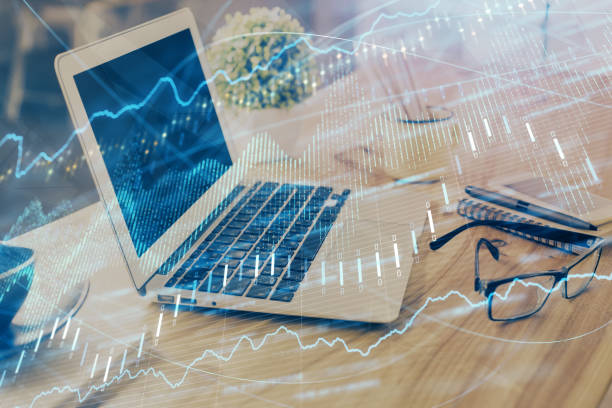istock Financial graph colorful drawing and table with computer on background. Double exposure. Concept of international markets. 1286408653