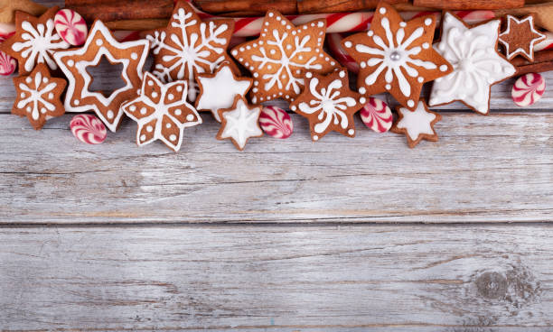istock Christmas Gingerbread Star Cookies and Candy on white rustic wooden background 1286408809