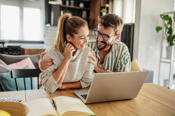 istock Happy couple using laptop at home 1286409719