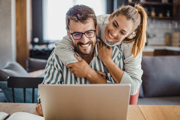 istock Happy couple using laptop at home 1286409831