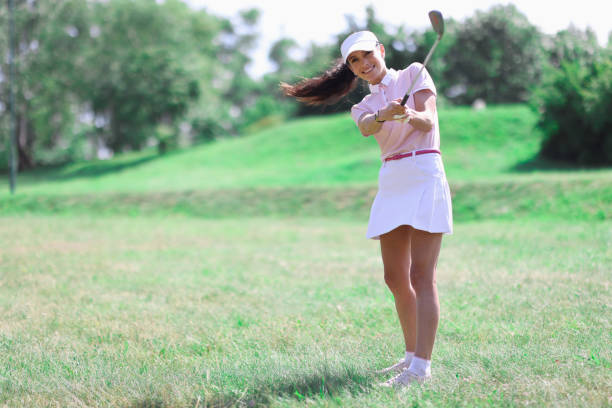 istock Woman golfer makes hit with golf club. 1286411544