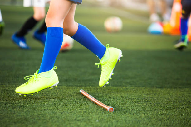 istock Selective focus to soccer players jumpping over hurdles marker. 1286414200