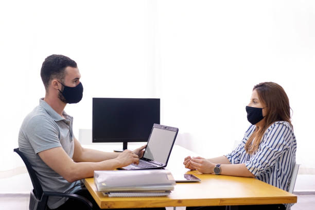 istock Man and woman at the office working together. 1286414215