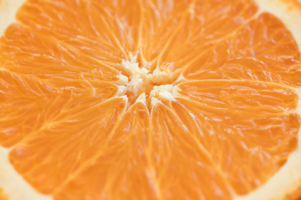 istock cut half of a fresh juicy textured orange, macro 1286414360