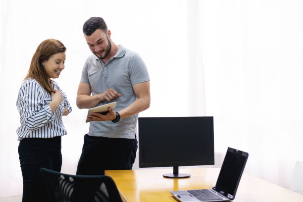 istock Man and woman at the office working together. 1286414548