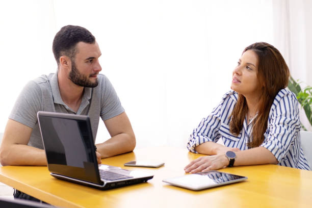 istock Man and woman at the office working together. 1286415025