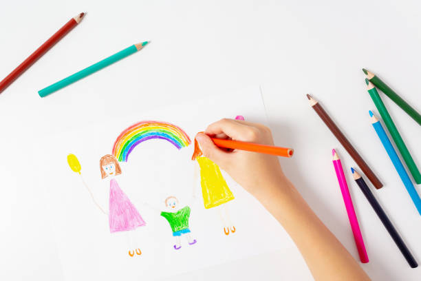 istock Child drawing his LGBT family. Top view. 1286415106