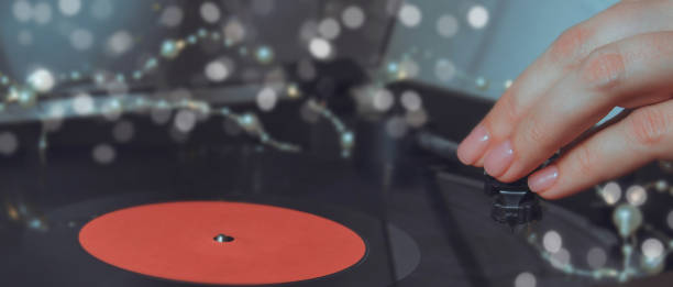 istock Xmas record playing on gramophone. Festive bokeh. 1286415107