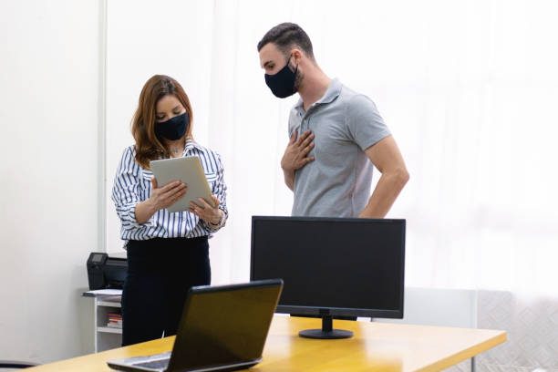 istock Man and woman at the office working together. 1286415113