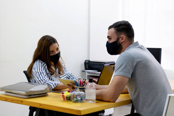 istock Man and woman at the office working together. 1286415127