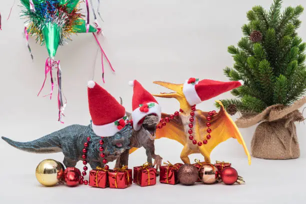 Photo of Toy dinosaurs with Santa Claus hats