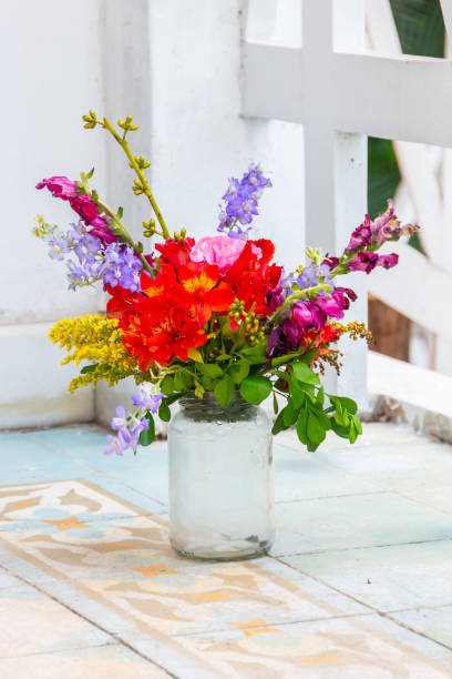 glass pot used as a vase with various flowers - flower pot vase purple decor imagens e fotografias de stock