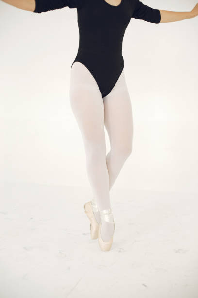 Ballerina posing in front of white background
