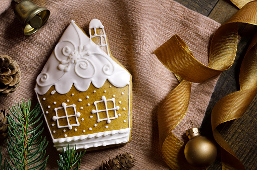 Christmas decoration with gingerbread house and pine tree branch