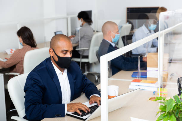 istock Manager in protective mask works for laptops in office 1286424206