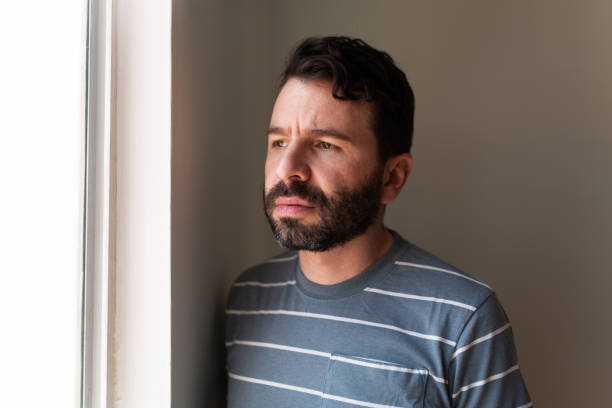 istock Man in his 30s suffering from loneliness at home 1286432392