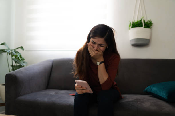 istock Latin woman crying because of a sad text message 1286432497