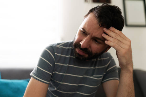 istock Melancholic man thinking and sitting on the sofa 1286432773