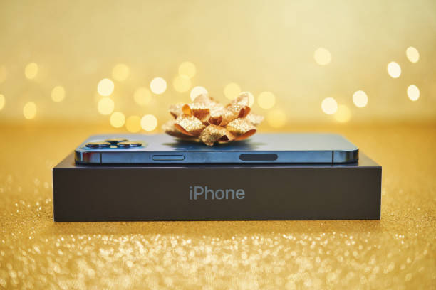 New iPhone in its box on a wooden table.