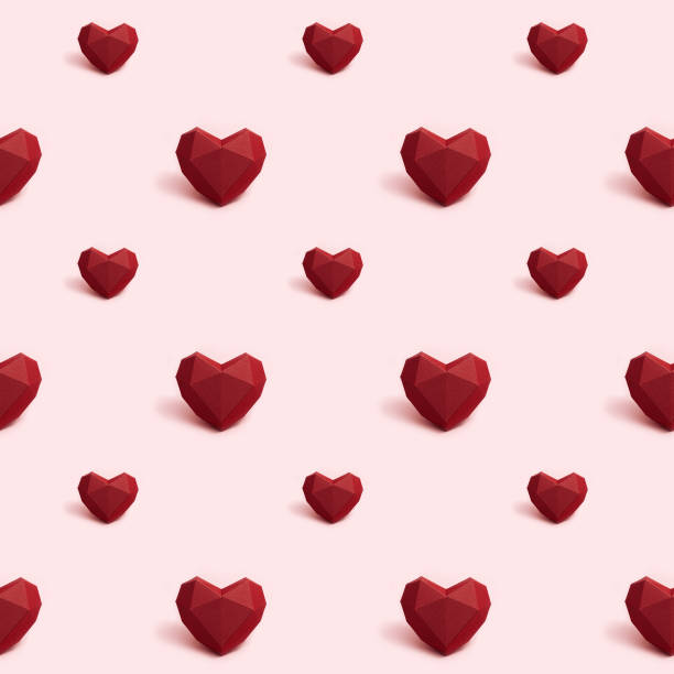 istock Seamless pattern with dark red polygonal paper heart on pink background. Wallpaper for Valentines Day. Love concept. Bright colors. Minimal style. 1286434523