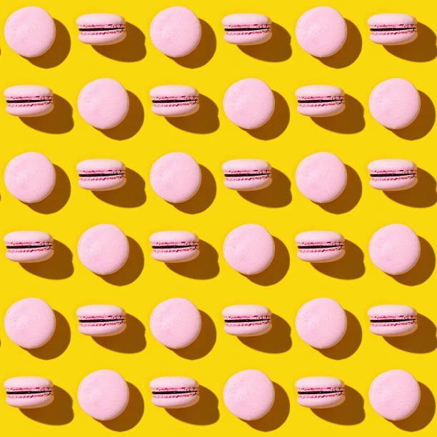 istock Seamless regular creative pattern of colorful french cookies macarons. 1286434531
