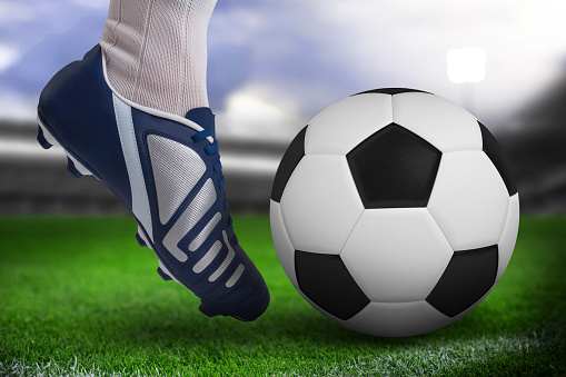 Uniform and ball with the flag of the WALES national team participating in Qatar 2022 with a grass floor on a white background.