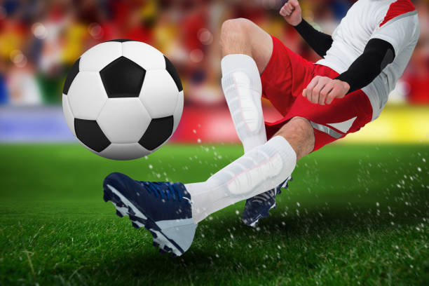 istock Composite image of football player in white kicking 1286434783