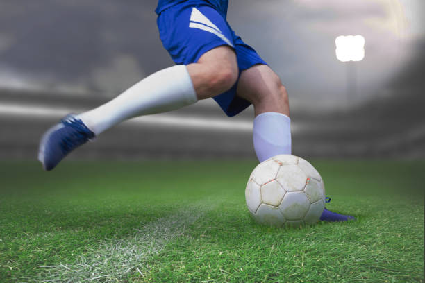 istock Composite image of football player kicking ball 1286435350
