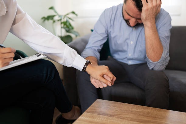 istock Pshychiatrist comforting a sad male patient 1286436498