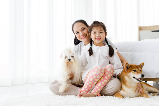 istock Mother and daughter with their dogs. 1286441374