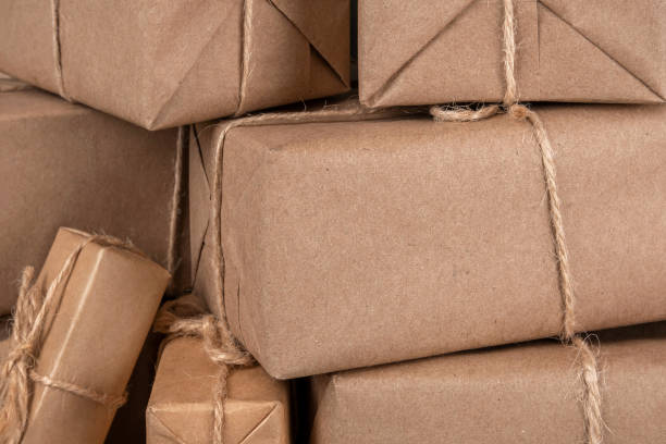 istock Boxes in craft paper with twine closeup. Holiday concept. Front view 1286441480