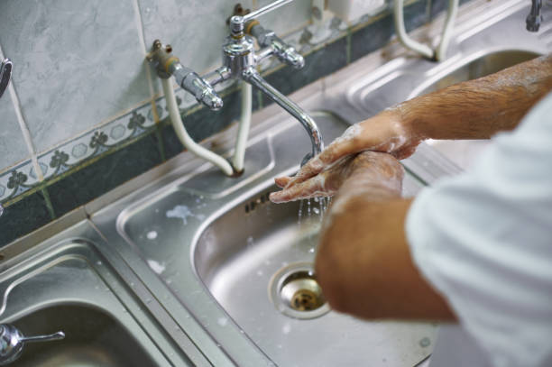 istock A surgeon in a white uniform washes his hands thoroughly. View from above. Hand treatment before surgery. 1286443130