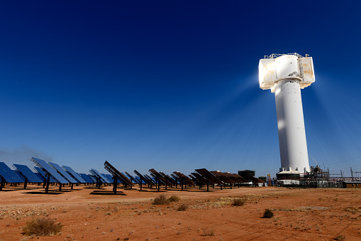 A low angle view of heliostats and generating tower at the Khi Solar One solar energy generation plant in the desert near Keimoes and Upington in the Northern Cape, South Africa.